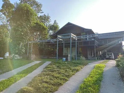 a house with a pathway in front of it at Coorg Countryside 1BR in Kushālnagar