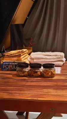 a table with jars of food on top of it at Cherry Blossoms Chalet in Kozhikode