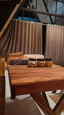 a wooden table with some food on top of it at Cherry Blossoms Chalet in Kozhikode