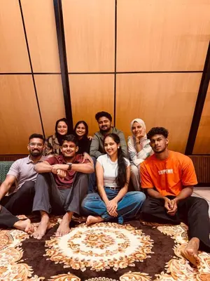 a group of people posing for a picture together at Cherry Blossoms Chalet in Kozhikode