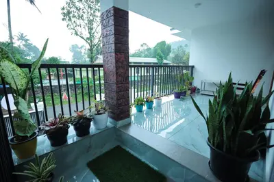 a balcony with a bunch of potted plants at Wayanadanhuts Home Stay in Sultan Bathery