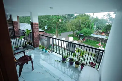 a balcony with potted plants and a view of a street at Wayanadanhuts Home Stay in Sultan Bathery