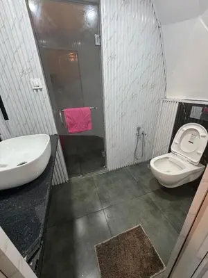 a bathroom with a sink and a toilet and a shower at Rivergreen resort in Athirappally