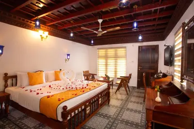 a bedroom with a large bed in a room at Koviloor Resort in Vattavada