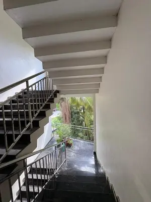 a stairway leading up to a white building at AC Arcade in Parli