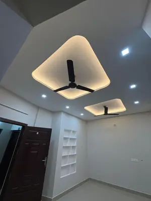 a ceiling fan in a room with a ceiling at AC Arcade in Parli