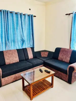 a living room with a couch and a coffee table at 3BHK Spacious Villa near Rajagiri Hospital in Ernakulam
