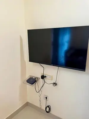 a flat screen tv hanging on a wall at 3BHK Spacious Villa near Rajagiri Hospital in Ernakulam