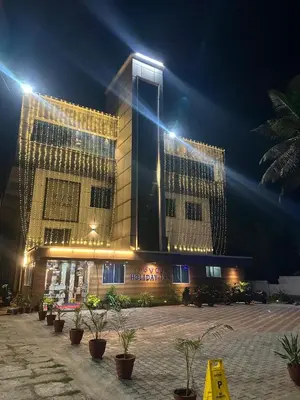 a building with lights on top of it at night at GVK Holiday Inn in Mysore