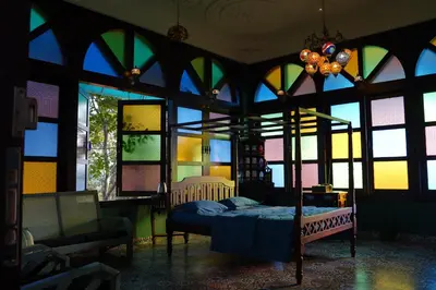 a bedroom with a bed in a room with windows at Room Marakkech Mazha at Samava Farms Calicut in Kozhikode
