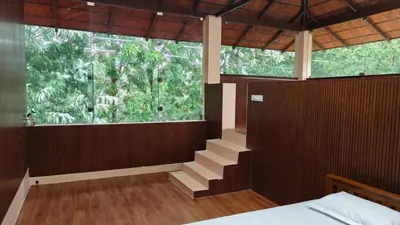 a bedroom with a large window and a stairway at Eagles Nest in Dimbam