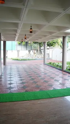 a large room with a tile floor and a building at Hotel Vintage Palace in Tattamangalam