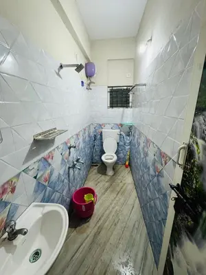 a bathroom with a sink and a toilet in it at Harmony Nests in Thattakād
