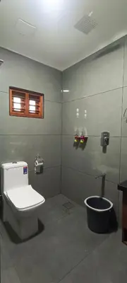 a bathroom with a toilet and a window at Dr Indulekhas Ayurvedic Wellness & Rejuvenation in Tellicherry