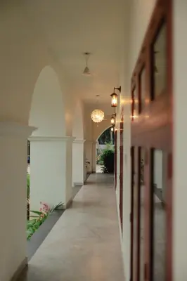 an empty hallway of a building with a light fixture at Kaayal Experience - Entire Home in Kozhikode in Kozhikode