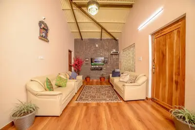 a living room with two couches and a tv at Spring Fields in Coimbatore