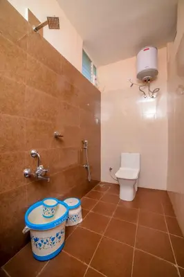 a bathroom with a toilet and a sink at Spring Fields in Coimbatore