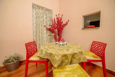 a dining room with a table and two chairs at Spring Fields in Coimbatore