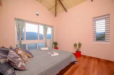 a bedroom with a bed and a large window at Spring Fields in Coimbatore