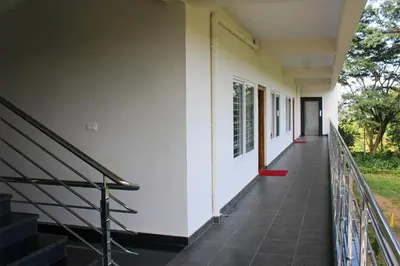 an empty corridor of a building with stairs at Jayasviinn Coorg in Virajpet
