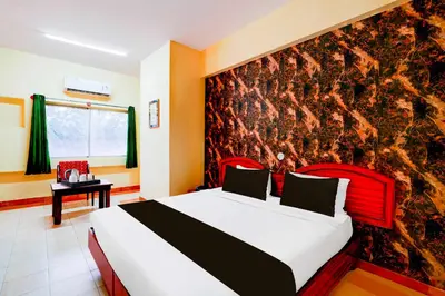 a bedroom with a large bed with a wall mural at Collection O Puthali Park Near Mysuru Railway Station in Mysore