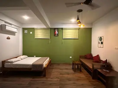 a room with a bed and a couch in it at DB GUEST HOUSE ARIMPUR - Unmarried couples and Stag groups not allowed in Trichūr