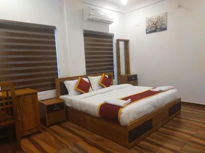 a bedroom with a large bed in a room at VGK Residency in Wayanad