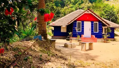 a blue and red house with a bench in front of it at Vintage Breeze Home Stay in Madikeri