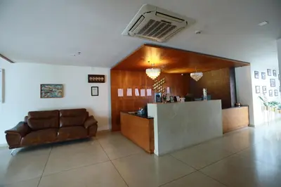 a lobby with a bar and a couch in a room at Devalokam Edappal in Edappāl