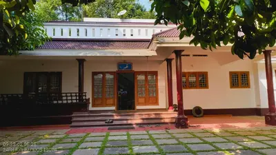 a house with a door and stairs in front at The Mangosteen Homestay in Kodanad