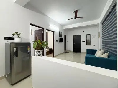 a living room with a couch and a blue couch at Lakshmi Home in Trichūr