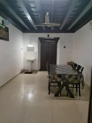 a room with a table and chairs and a door at Thiruvambady Heritage Homestay in Trichūr