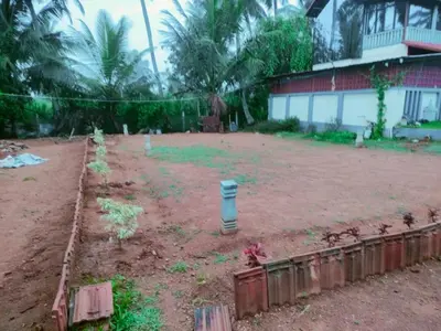 a garden in front of a house with a fence at MVR Home Stay in Seringapatam