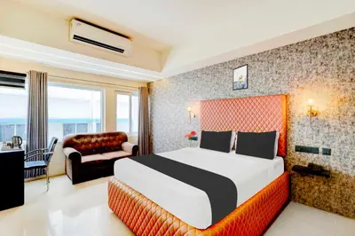 a hotel room with a bed and a couch at Collection O City Bus Station Mysuru in Mysore
