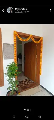 an entrance to a room with an orange garland over a door at La- casona in Kottayam