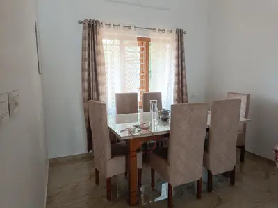 a dining room with a table and chairs at La casona in Kottayam