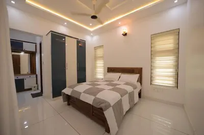 a bedroom with a bed and a television in it at Village Pavilion in Tellicherry