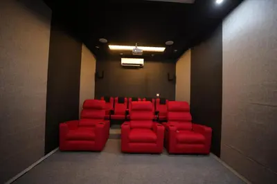 a conference room with red chairs in a room at Village Pavilion in Tellicherry