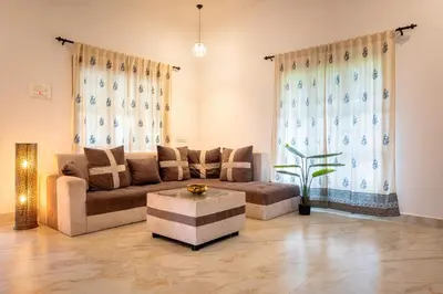 a living room with a couch and a coffee table at Meenakshi residency in Alāndurai