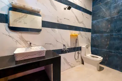 a bathroom with a sink and a toilet at Meenakshi residency in Alāndurai