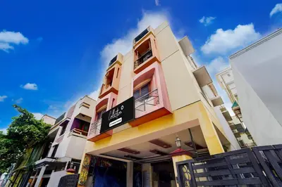 a building with a sign on the side of it at Super Collection O Omni Bus Terminal Gandhipuram Formerly Apple Grand in Coimbatore