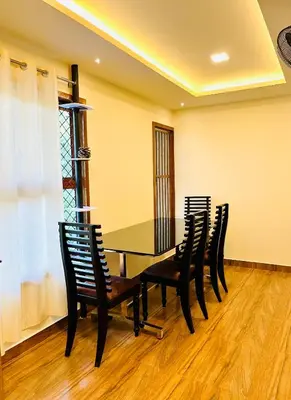 a dining room with a table and chairs at Joevilla - 3BHK Near Kottiyoor in Kelakam
