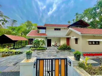 a house with a fence in front of it at Eden Villa in Meenangadi
