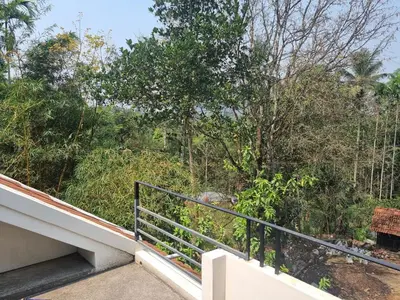a balcony with a view of a forest at Eden Villa in Meenangadi