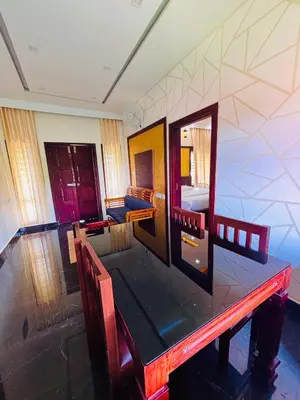 a dining room with a wooden table and chairs at Vaca Vibes Resorts in Koroth