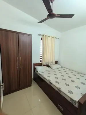 a bedroom with a bed and a ceiling fan at Little Villa East Fort in Trichūr