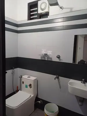 a bathroom with a white toilet and a sink at Dream Stay Mukkam in Mukkam