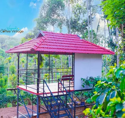 a red roofed gazebo with a red roof at Wayanad Coffee Vintage in Wayanad