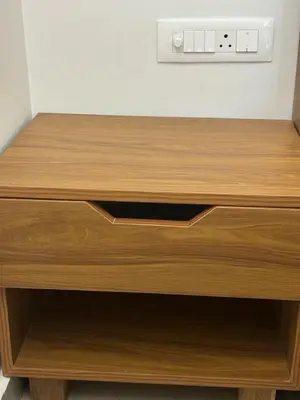a wooden desk with a drawer in a room at Maitree Serenity Farm Stay