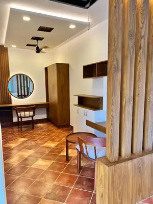 a room with a table and chairs and a mirror at Riverside Luxury Private Pool Villa in Athirappilly in Athirappally